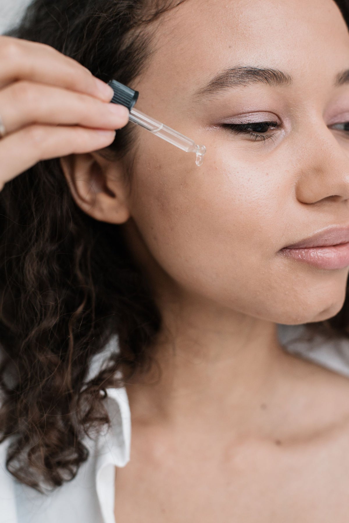 Facial serum applied gently with a glass dropper